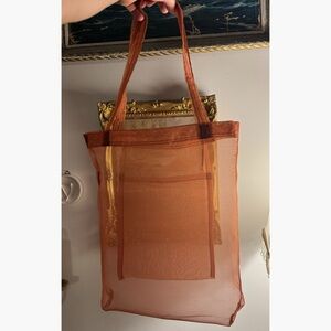 Sheer tote bag in rust orange organza to showoff items you’re carrying